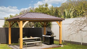 A wooden gazebo with a metal roof, a barbecue grill, and a picnic table with benches. - 'Sopra'  Shoal Bay - Close to the beach (Shoal Bay)