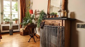 A room with a wooden cabinet, a radiator, and various potted plants. - CLOS REMY (Précy-sur-Oise)