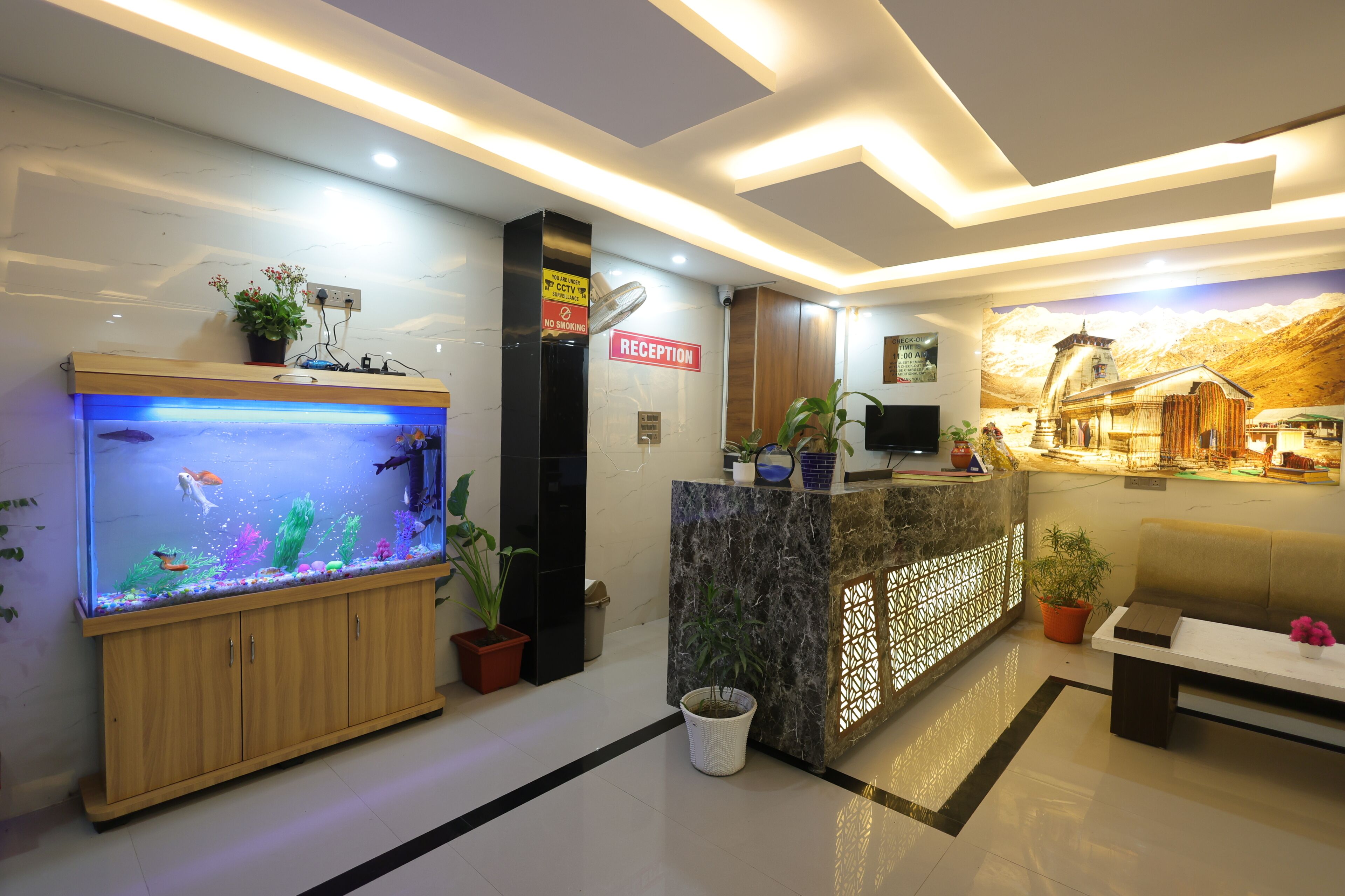 A reception area with a reception desk, a large aquarium, and a mural on the wall.