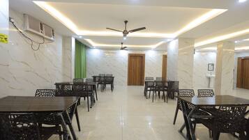 A conference room with marble walls, ceiling fans, and a tiled floor.