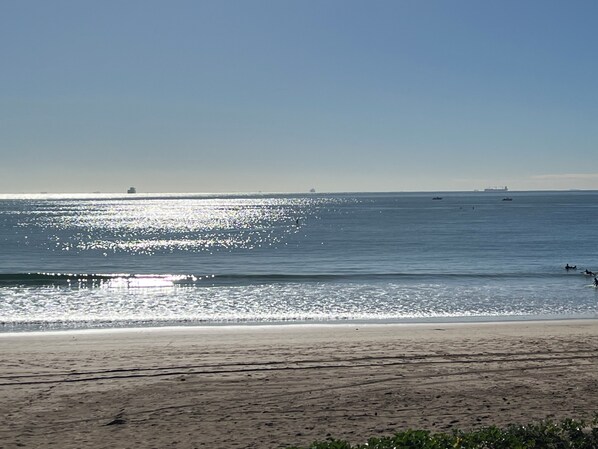 A beach with a clear sky and calm sea.
