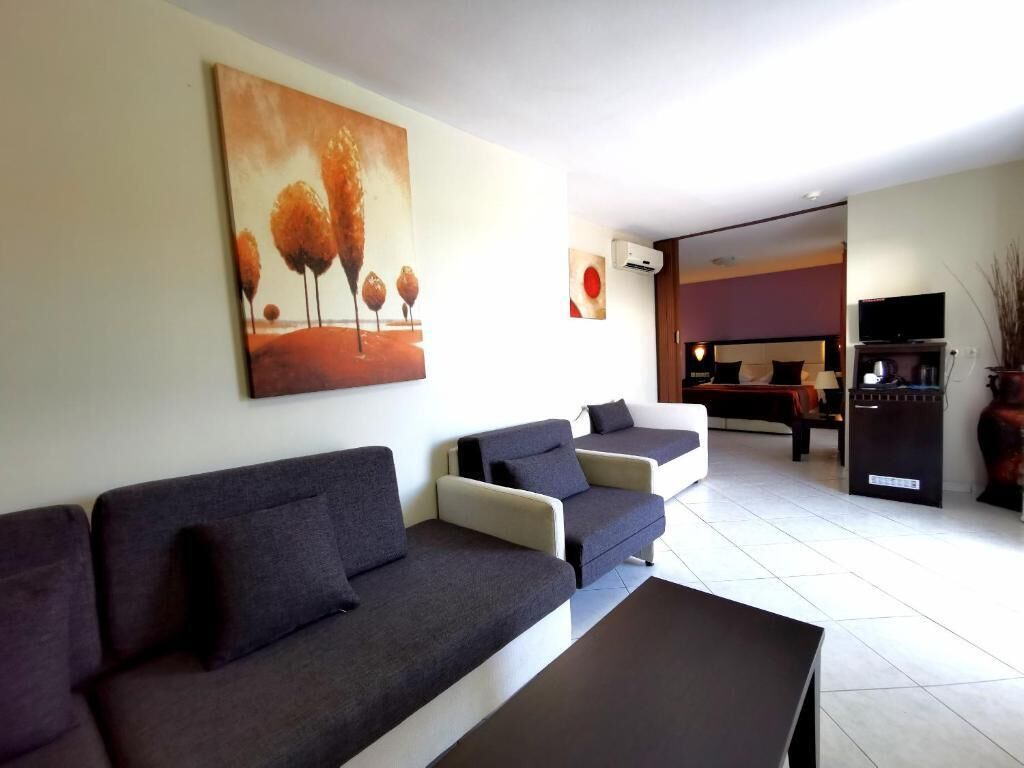 Un salón con sofás, una mesa de centro y un cuadro en la pared.