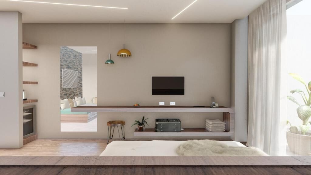 A modern living room with a flat-screen TV mounted on the wall, a sofa, a coffee table, and a small side table with a plant.
