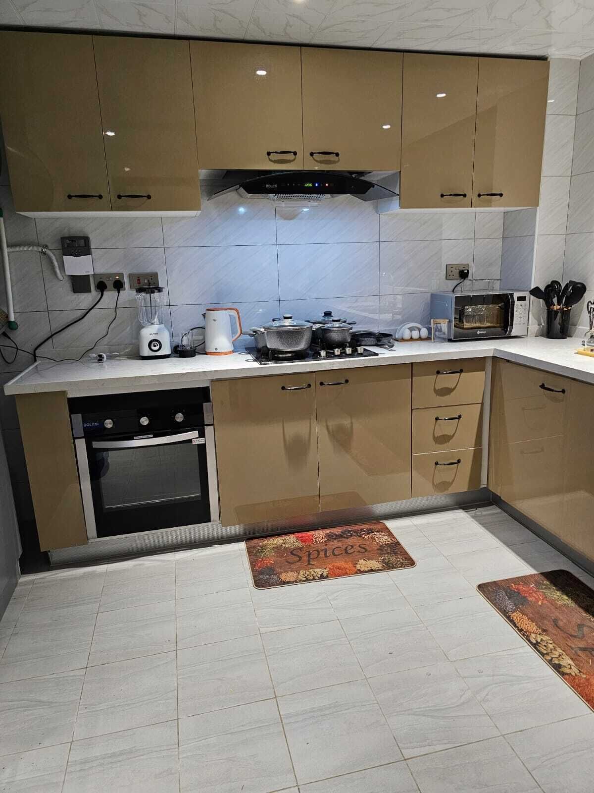 A modern kitchen with a built-in oven, microwave, and gas stove.