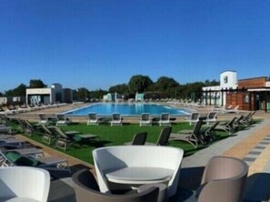 A swimming pool with lounge chairs and a clear sky. - Tattershall Lakes Country Park - Holiday Accommodation 16605 (Lincoln)