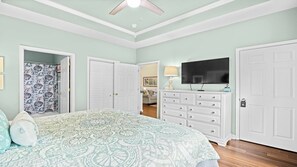 A bedroom with a bed, a dresser, a television, and a closet. - 933 Willow Bend - Barefoot Resort Rentals (North Myrtle Beach)