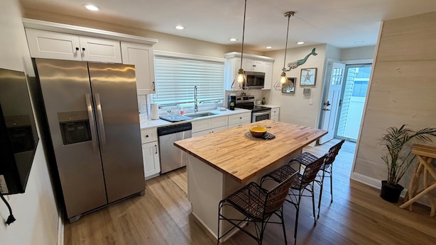 A modern kitchen with a central island, stainless steel appliances, and pendant lighting. - 3 bedroom 2.5 bath Townhome just a few short blocks to the beach. (Wildwood Crest)