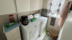 A compact laundry area with a washing machine, a coffee maker, and a pet wipes dispenser. - 3 bedroom 2.5 bath Townhome just a few short blocks to the beach. (Wildwood Crest)