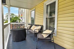 A covered porch with two chairs and a table, a railing, and a window. - Near Wineries | Sleeps 9 | Walking distance to Geneva (Geneva)