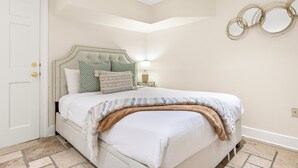 A bedroom with a bed, a nightstand, a lamp, and a door. - Best Location Near Madison Square, Walk Everywhere by Lucky Savannah (Savannah)