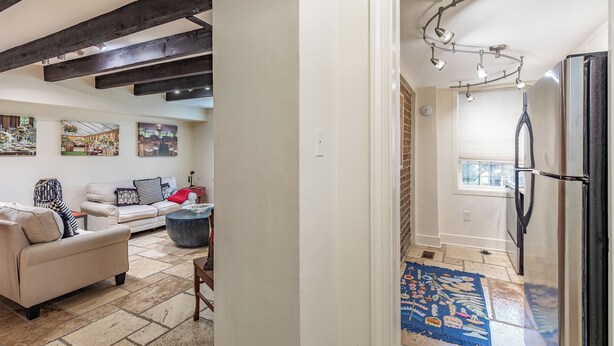 A modern living room with a sofa, coffee table, and artwork on the wall. - Best Location Near Madison Square, Walk Everywhere by Lucky Savannah (Savannah)