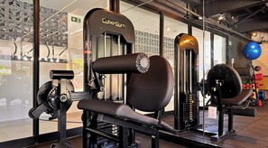 A gym with various exercise equipment including a bench press, a squat rack, and a cable machine. - NOA Residence Club - LikeHome  (Cabedelo)