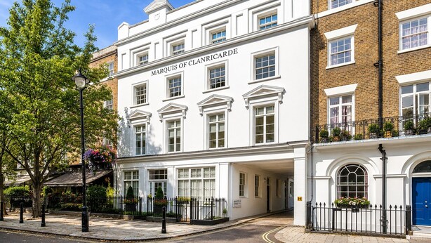 A historic building with a white facade, multiple windows, and a prominent nameplate. - Hyde Park Premium Duplex Apartment (London)
