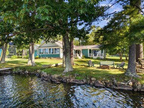 A lakeside property with a house, a dock, and a bench. - Camp Crocker Lakefront Home & Dock (Monmouth)