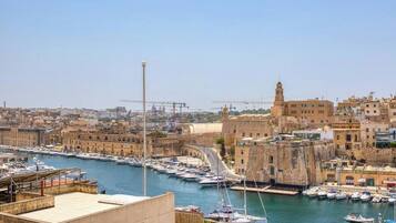 A harbor with boats, a prominent tower, and historic buildings.