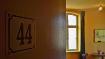 A room with a door labeled '44' and a window with a view of the outside.