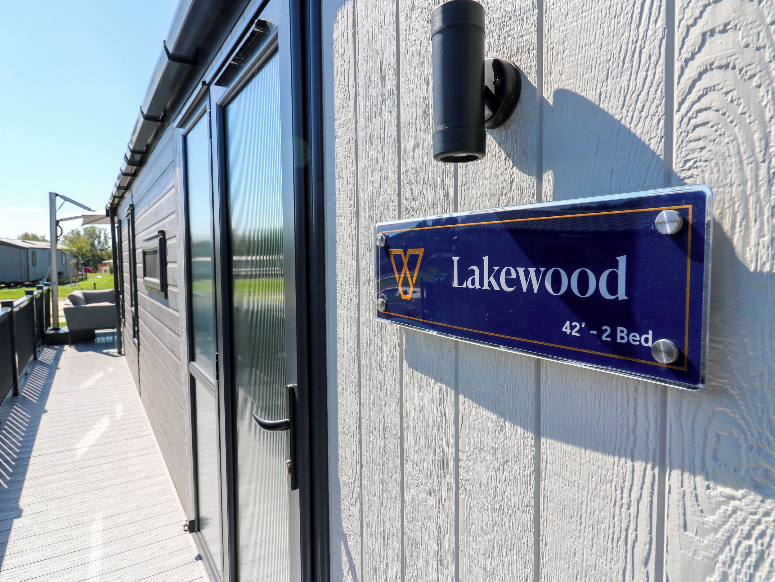 A sign indicating 'Lakewood 42' - 2 Bed' on a building facade.