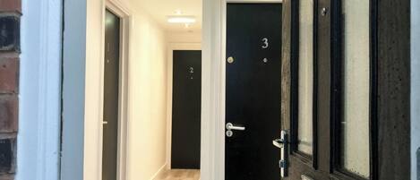 A hallway with doors numbered 2 and 3, leading to rooms.