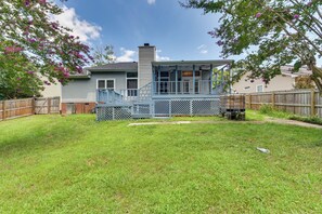 A residential house with a covered porch, a brick chimney, and a fenced backyard. - Matthews Family Home w/ Fenced Yard! (Matthews)