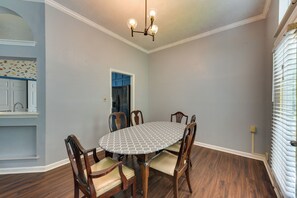 A dining area with a round table, four chairs, and a chandelier. - Matthews Family Home w/ Fenced Yard! (Matthews)