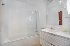 A modern bathroom with a glass-enclosed shower, a white sink, and a mirror above the vanity. - Pollensa Villa With Private Pool (Pollença)