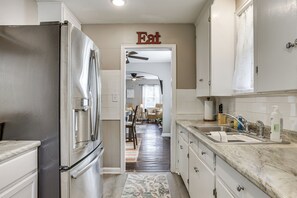 A kitchen with a stainless steel refrigerator, a sink with a faucet, and a countertop with a bottle of dish soap. - 4 Mi to Downtown Columbus! Updated Home w/ Yard (Columbus)