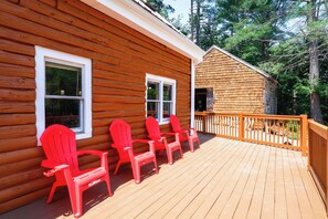 A wooden cabin with a deck, two windows, and a small shed. - Classic New England Cabin on Belleau Lake (Wakefield)