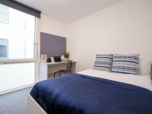 A bedroom with a bed, a desk, and a chair. - Student Only The Paper Works (Sheffield)