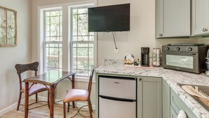 A kitchen with a built-in oven, a coffee maker, and a refrigerator. - On-site Trout Stream & Fire Pit! Murphy Tiny Home (Murphy)