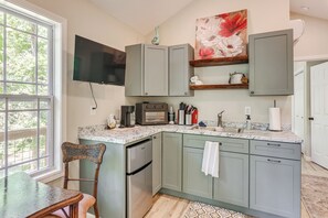 A kitchen with a built-in oven, a coffee maker, and a flat-screen TV mounted above the counter. - On-site Trout Stream & Fire Pit! Murphy Tiny Home (Murphy)
