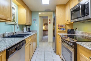 A kitchen with granite countertops, stainless steel appliances, and wooden cabinets. - Steps to the Slopes! Breck Ski Condo w/ Fireplace (Breckenridge)