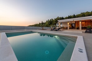 A modern pool with a clear blue water surface, surrounded by a concrete deck. - Villa Casa Olea Zadarvillas (Benkovac)