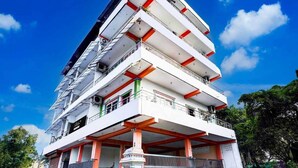 A multi-story building with balconies and a gated entrance. - Townhouse R S Puram Junction (Coimbatore)