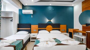 Deluxe Triple Room, Balcony | Desk, laptop workspace, WiFi (free), bed sheets