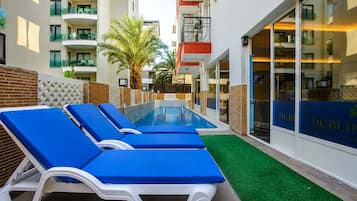 Outdoor pool, open 6:00 AM to 8:00 PM, free cabanas, pool umbrellas