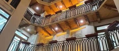 A multi-level building with balconies, staircases, and decorative windows.
