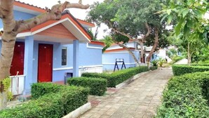 A residential area with blue houses, red doors, and a paved pathway. - Scarlet Sails Resort Koh Rong (Koh Rong)