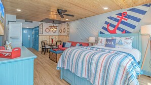 A nautical-themed bedroom with a bed, a desk, and a dining area. - Yachtsman S503B Studio (Myrtle Beach)