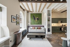 A modern living room with a sofa, coffee table, and artwork on the wall. - Preachers Yard (York)