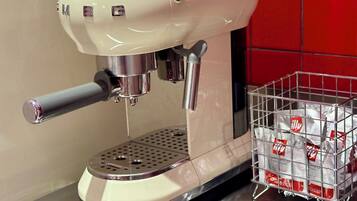 A coffee machine with a metal basket containing coffee pods.