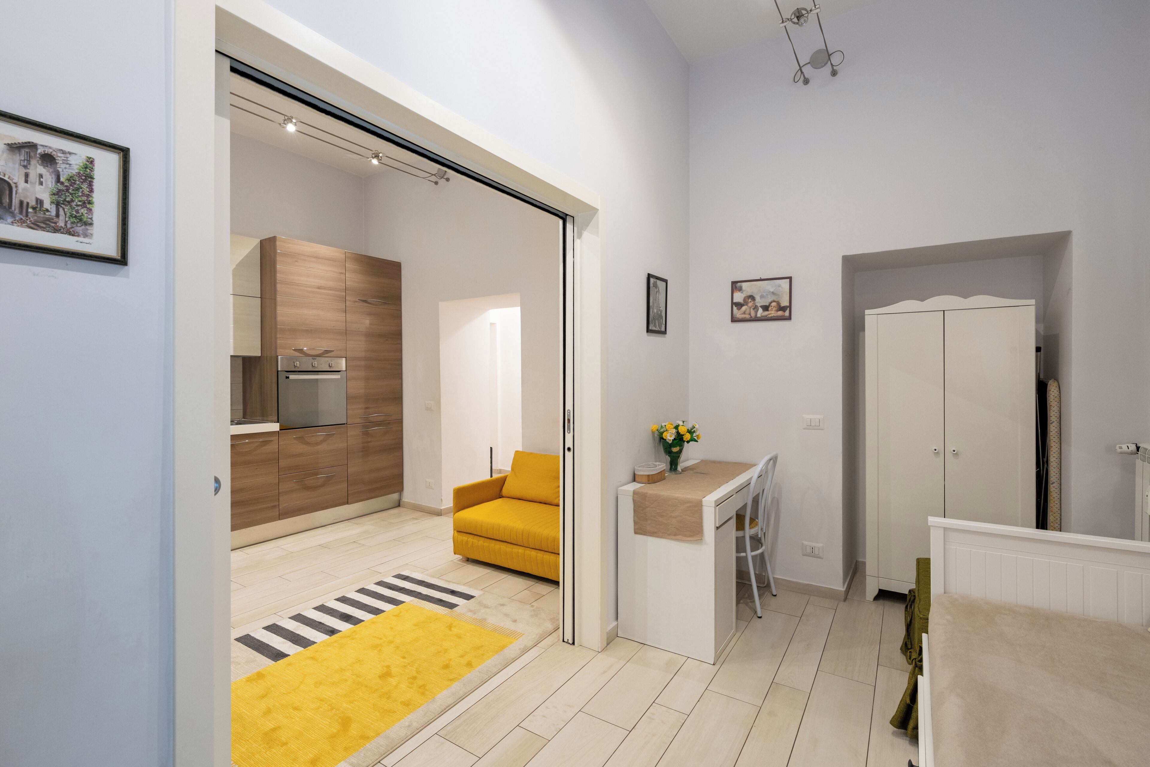A modern apartment with a kitchen, a dining area, and a living space.