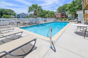 A rectangular swimming pool with a white deck, surrounded by lounge chairs and a white fence. - Walk to the Beach 2 BR Condo with a Shared Pool! Colony III 201 (Surfside Beach)