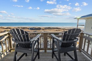 A deck with two Adirondack chairs overlooking a beach. - Seabiscuit-Oceanfront Home with Private Pool (Atlantic Beach)