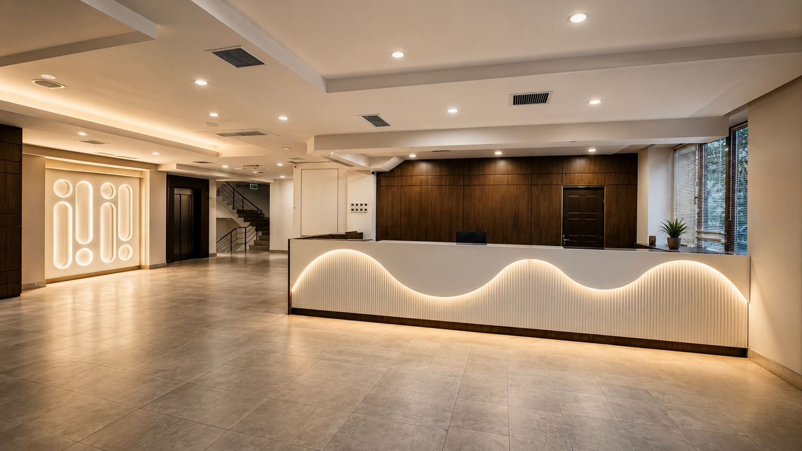 A modern reception area with a curved reception desk, a staircase, and a large illuminated sign.