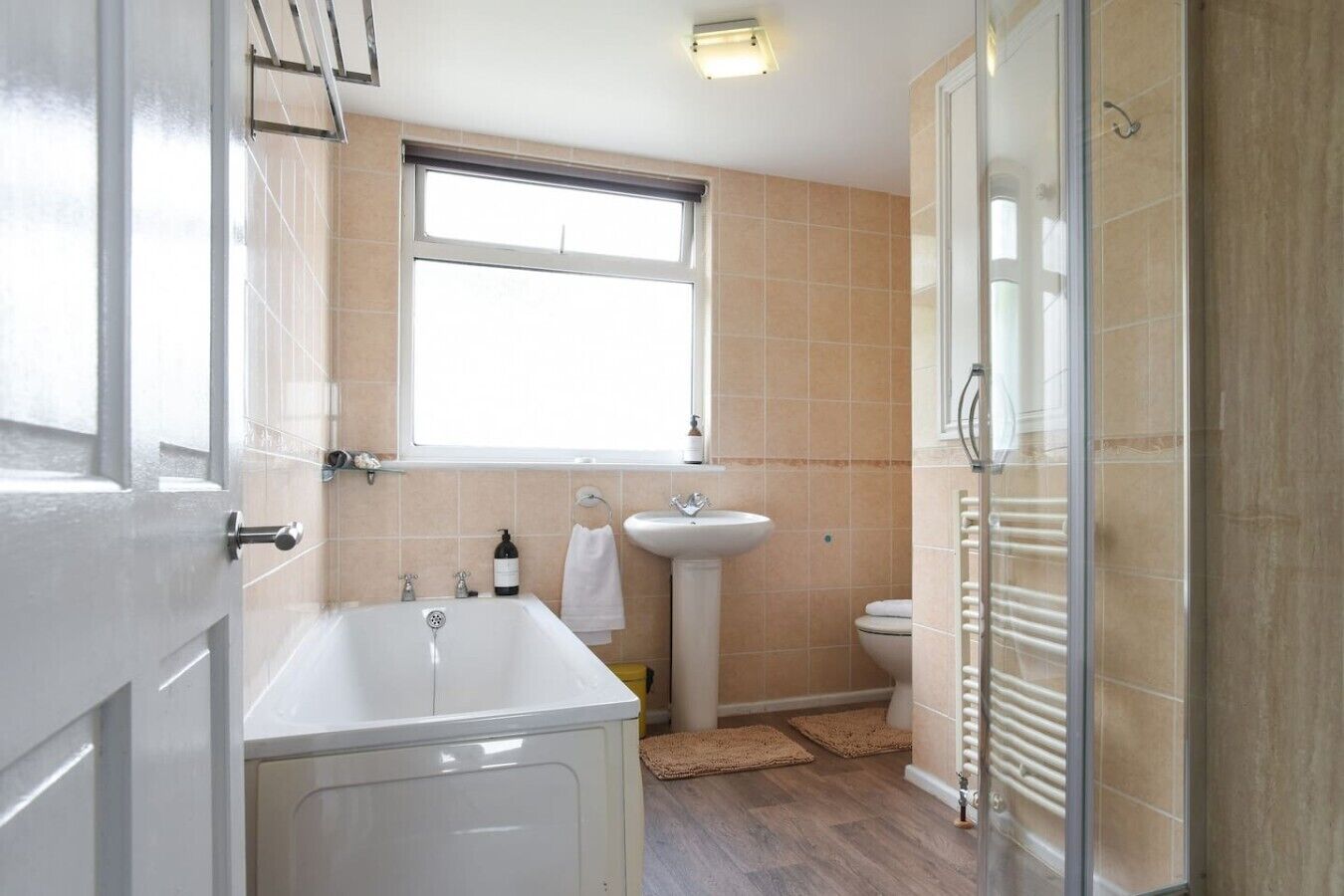 A bathroom with a bathtub, a sink, and a toilet.