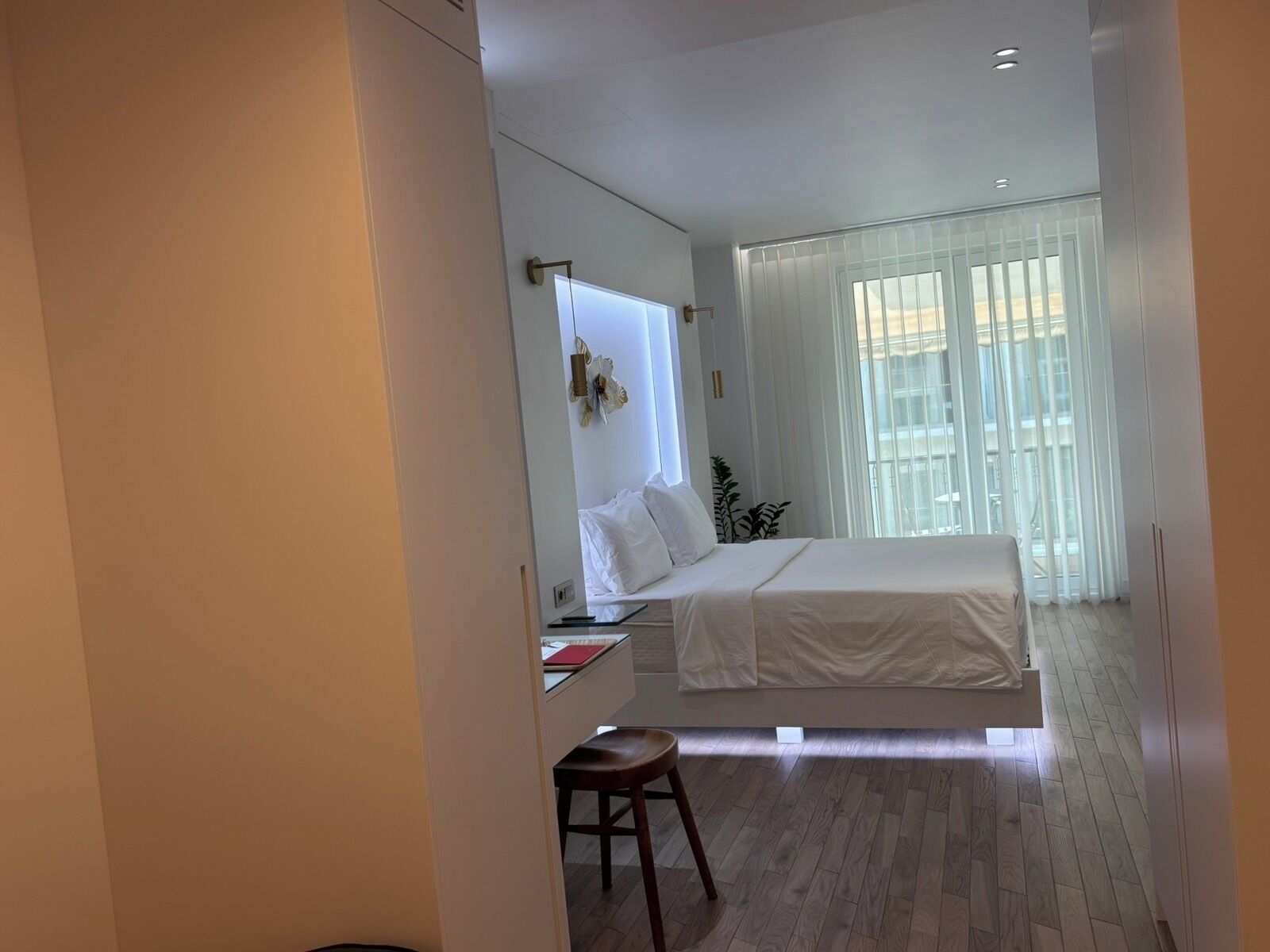A modern bedroom with a bed, a desk, and a chair.