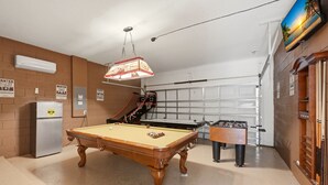 A pool table with a foosball table and a basketball hoop in a recreational room. - Modern 6BRPoolVilla w/HotTub &GameRoom Near Disney (Kissimmee)