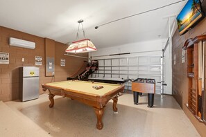A pool table with a foosball table and a basketball hoop in a recreational room. - Modern 6BRPoolVilla w/HotTub &GameRoom Near Disney (Kissimmee)