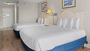 A hotel room with two beds, a wooden floor, a white door, and a lamp. - Sea Mist 51112 Ocean View Vacation Rental (Myrtle Beach)