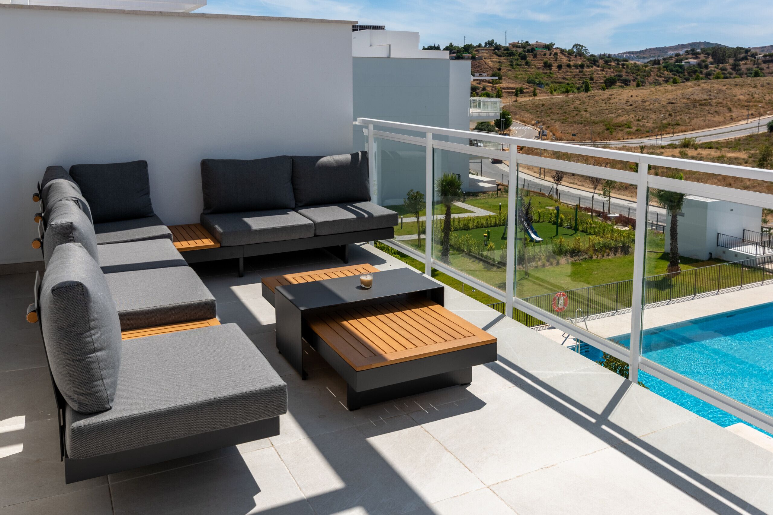 A modern outdoor seating area with a pool view.